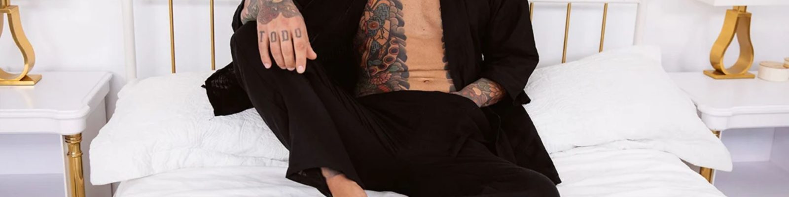 Juan Lucho in black kimono on bed
