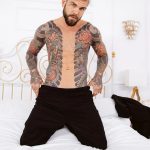 Juan Lucho tattooed Latino topless on bed