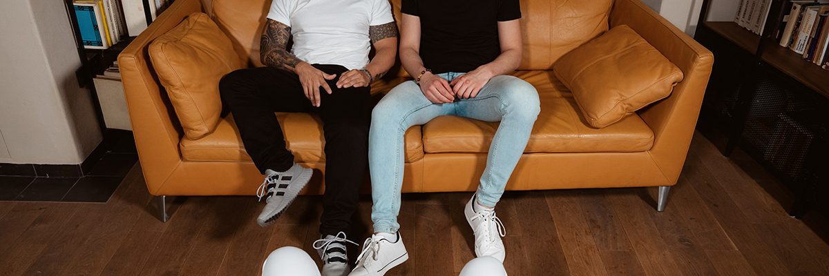 two bisexual men sitting on sofa