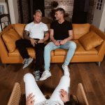 two bisexual men sitting on sofa